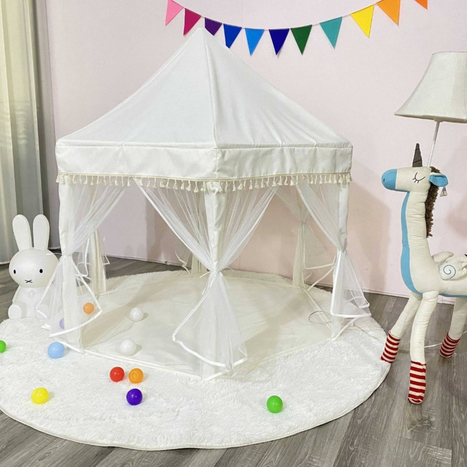 Pink hexagonal princess castle play tent with curtained doors and mesh windows